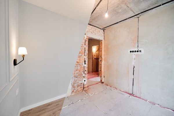 Photo collage of apartment room before and after restoration or refurbishment. Old room with doorway and new renovated living room with parquet floor and elegant interior design.